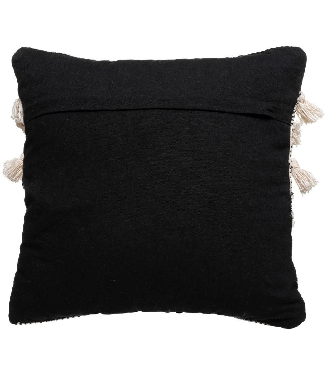 Coussin blanc et noir à motif en relief avec pompons